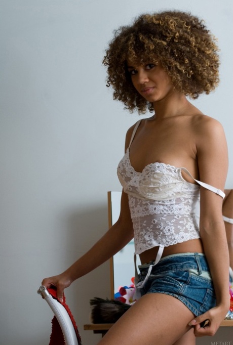 Adorable curly haired teen Asis A shows her slim figure and poses in her room