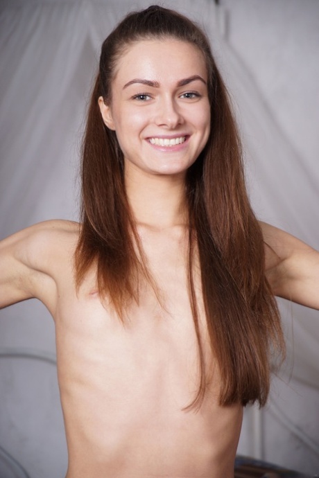 Gorgeous slender babe Avita doffs her bodysuit and poses nude in a solo
