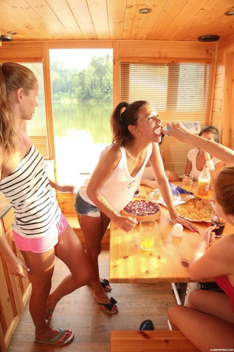 Sweet teens with small tits toy each other on a boat on the river