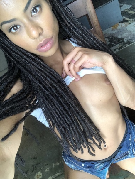 Beautiful ebony teen Kira Noir reveals her hot ass and tiny tits in a solo