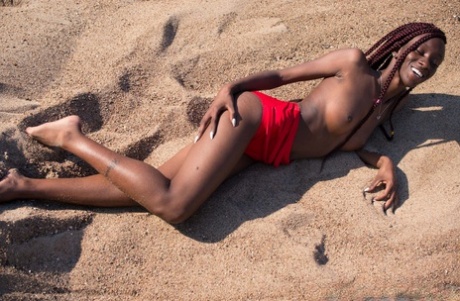 Hot Ebony Angel 19 goes topless and shows her medium tits in the desert