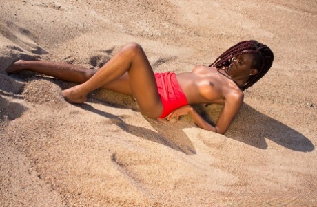 Hot Ebony Angel 19 goes topless and shows her medium tits in the desert