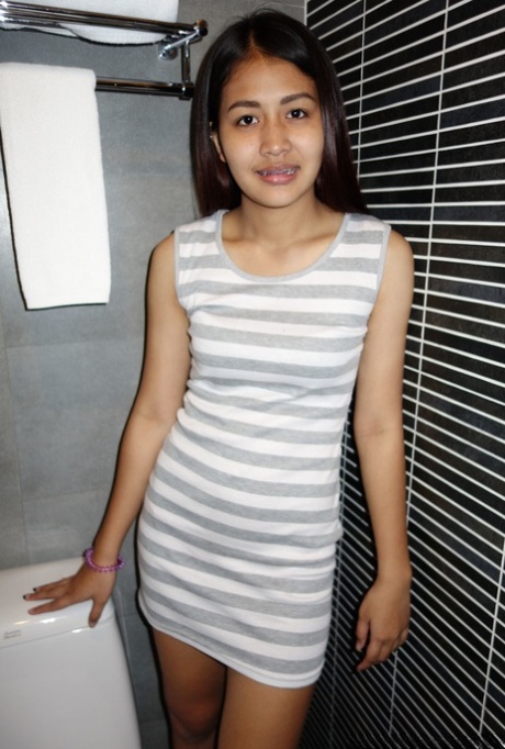 Asian babe Fon shows her small tits & her big ass during a sexy striptease
