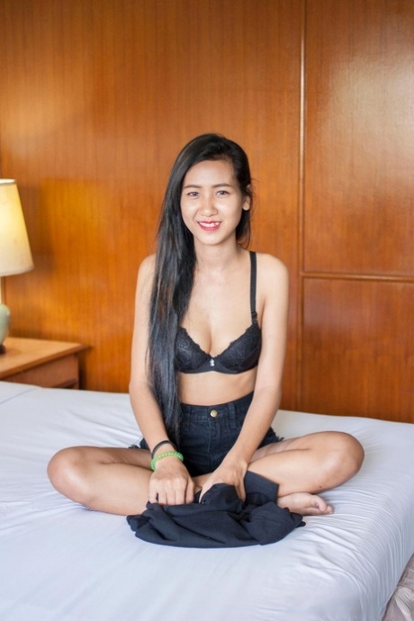 Pretty Asian babe Pop shows her creampied pussy after a hot striptease