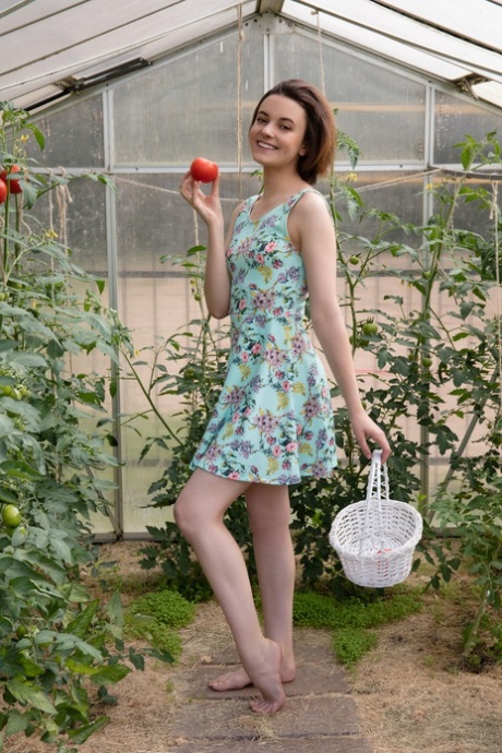 Skinny teen Kertu removes her dress and poses nude in the greenhouse